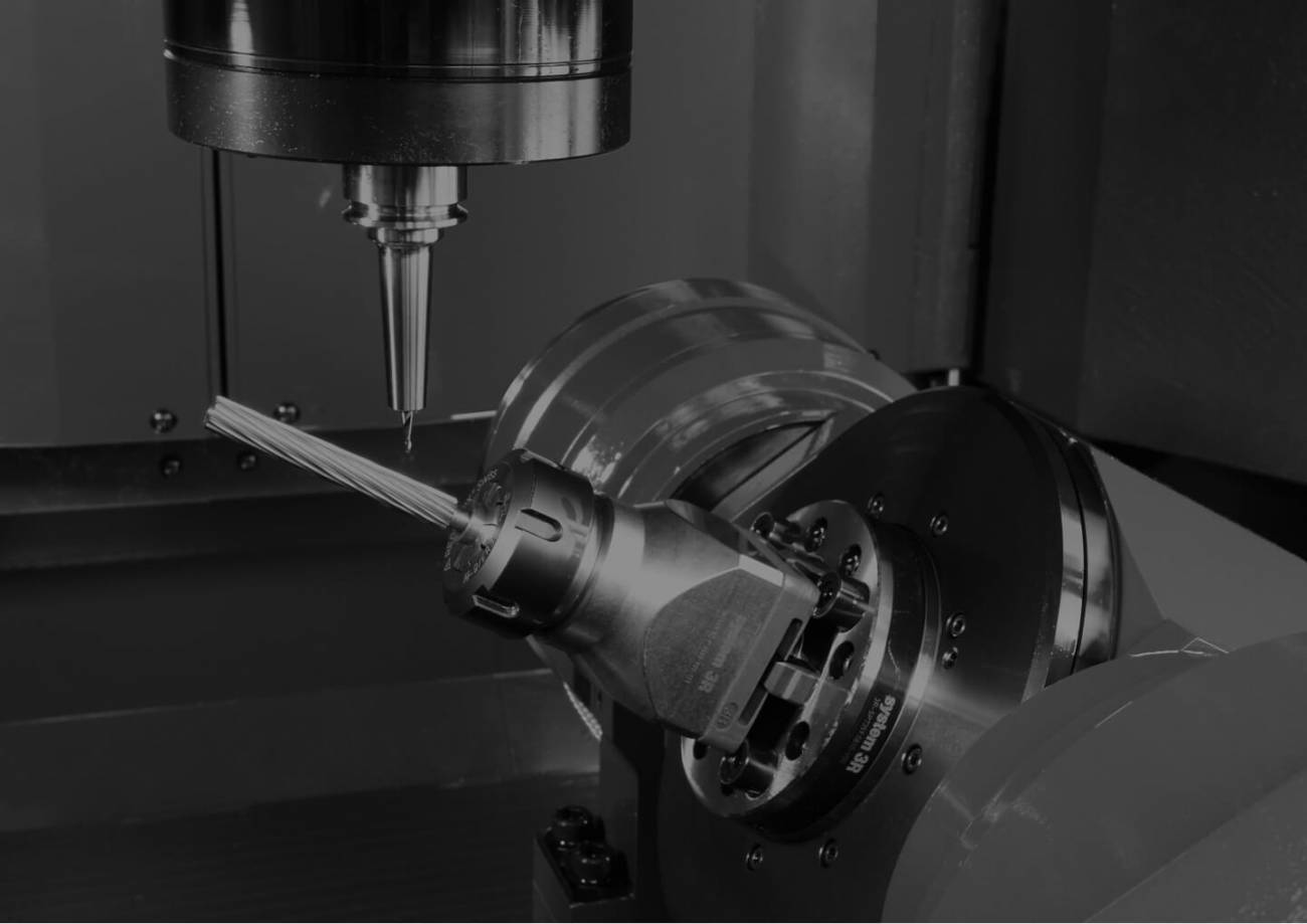 inside of a five-axis CNC machine tool as its lathe is machining a part