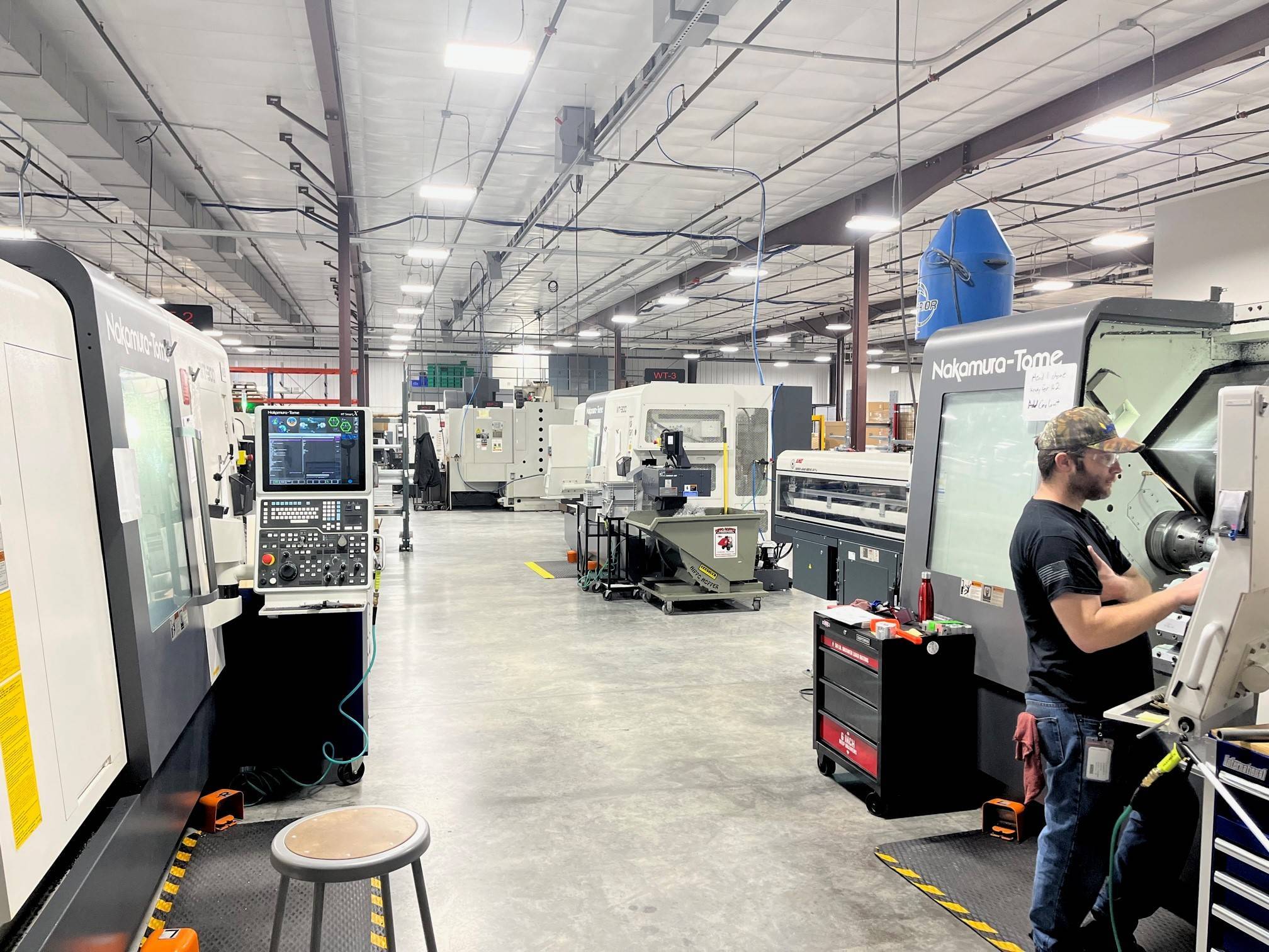 Nakamura-Tome CNC machine tools on a precision manufacturing shop floor