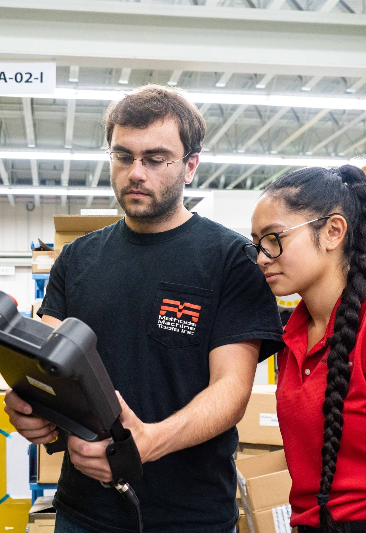 One employee demonstrating a device to another