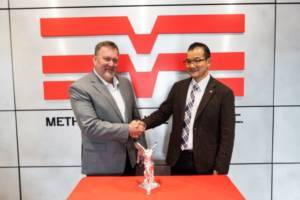 Dale Hedberg, Methods COO, and Yasushi Kimura, President of Yasda Precision America Corporation, shake hands at Methods headquarters