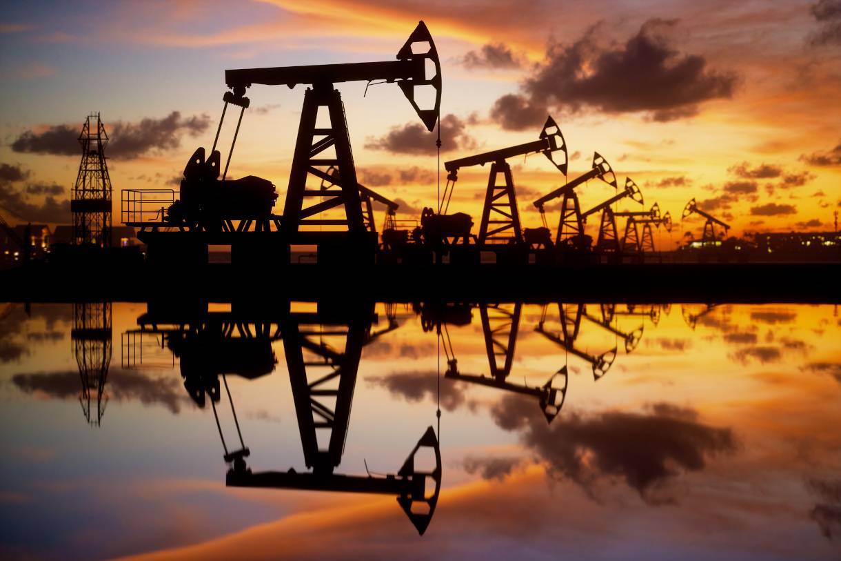 Photo of oil derricks at dusk