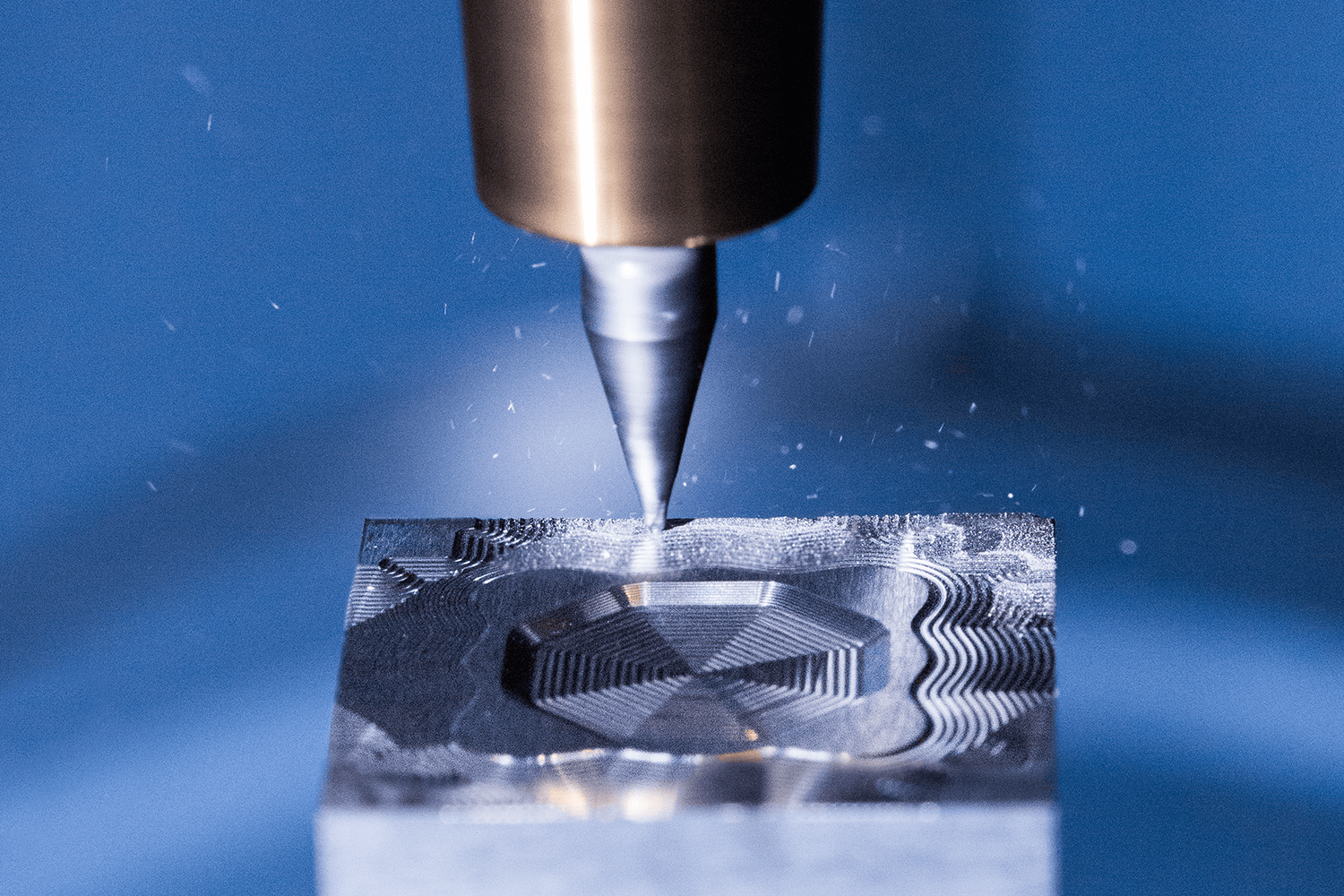 Close-up photo of a YMC-430 at work cutting a pattern in steel