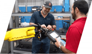 Two men working on a FANUC machine